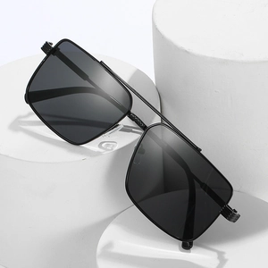 Classic double bridge square metal sunglasses with dark lenses on a white pedestal
