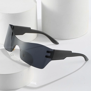 Lunettes de soleil enveloppantes minimalistes à verres gris sur socle blanc