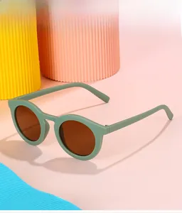 Detail of matte Morandi green round frame kids sunglasses with dark brown lenses
