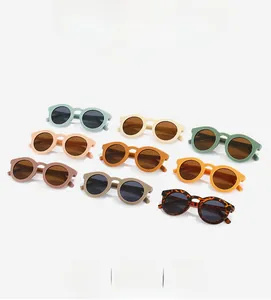 Flat lay of vintage round frame kids sunglasses in nine various matte Morandi colors
