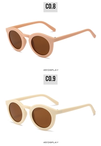 Detail view of round children's sunglasses in beige and soft pink colors from a 45-degree angle