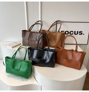Detail of woven leather tote bags in five colors on geometric display stands