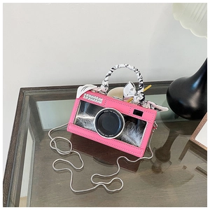 Pink vintage camera-shaped crossbody bag with a transparent window and silk scarf handle
