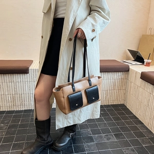 Close-up of vintage brown crossbody bag with double front pockets and silver studs