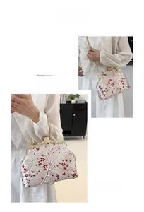 Detail of elegant Chinese embroidery handbag with pearls and gold metal chain