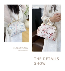 Detail of embroidered floral handbag with pearl clasp and elegant metal chain strap