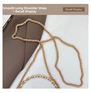 Detailed macro of golden bamboo handle and woven metal chain strap for evening handbag