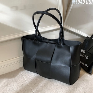 Large black woven leather tote bag for women with wide intrecciato pattern and thin handles