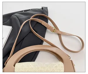 Detail of adjustable leather shoulder strap and woven texture on beige crossbody bag