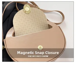 Detail showing magnetic snap closure and woven texture lining on beige saddle bag