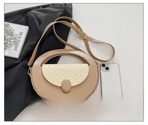 Minimalist khaki leather crossbody bag shown next to a smartphone for size reference