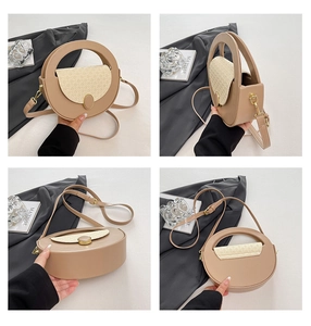Close-up of a round crossbody bag featuring woven texture and metallic clasp details