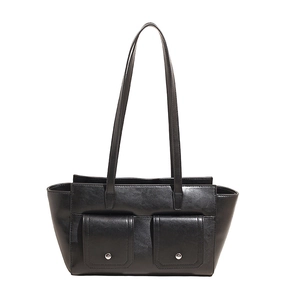 Minimalist black faux leather tote with dual front flap pockets and silver hardware detail