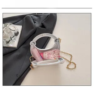 Interior view of white crescent bag showing storage capacity for lipstick and hand cream