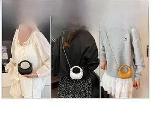 Three acrylic crescent handbags in black, white, and yellow with gold chain straps