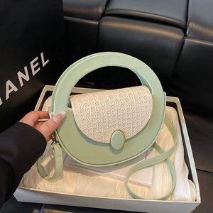 Minimalist light green semi-circular handbag with woven texture and round top handle