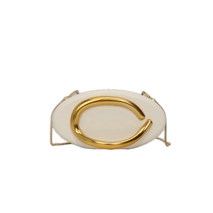Elegant white oval hardshell clutch bag with gold C-logo buckle and delicate chain strap