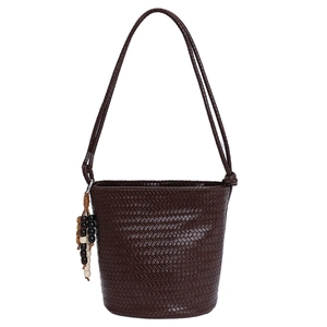 Dark brown woven tote bag with diamond pattern, long shoulder strap and colorful bead charm