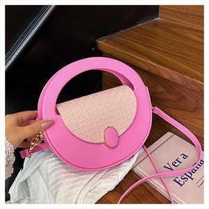 Detailed pink crossbody bag featuring woven flap texture and gold metal buckle on steps