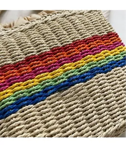 Close-up of the hollow woven texture and colorful rainbow stripes on the straw bucket bag