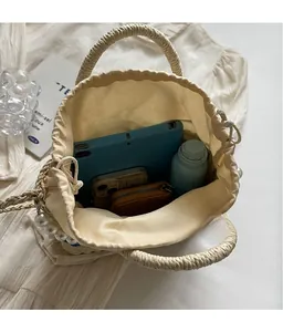 Internal view of rainbow straw bucket bag showing storage space for tablet and essentials