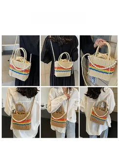Detail of straw woven bucket bag with rainbow stripes and elegant pearl strap