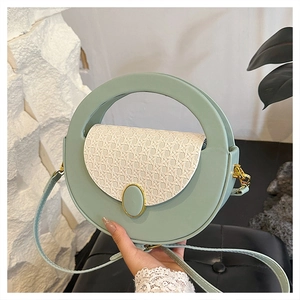 Detailed close-up of mint green leather and rattan flap on a vintage crossbody bag