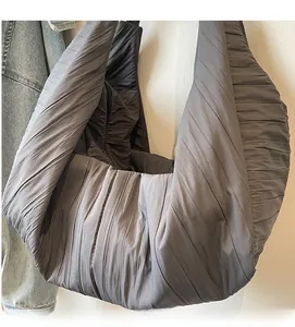 Detail of deep grey hobo bag showing pleated fabric texture and soft material finish