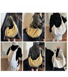 Detail of large pleated hobo bag with adjustable strap and minimalist texture