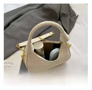 Interior view of beige crescent bag showing capacity for makeup and daily items