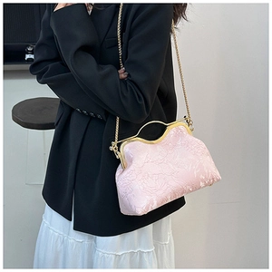 Detailed view of pink floral jacquard embroidery on a retro shell frame bag