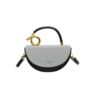 Modern bicolor saddle bag with grey woven texture, black leather and gold metal ring handle