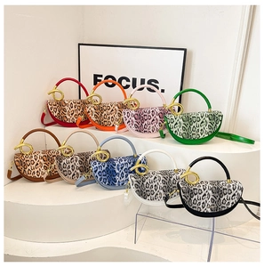 Multiple stylish leopard print saddle bags with metallic circular handles displayed in a grid