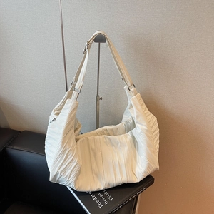 Solid cream oversized dumpling shoulder bag with pleated texture and wide strap