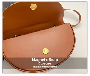 Detail view of the magnetic closure and internal compartment of this leather saddle bag