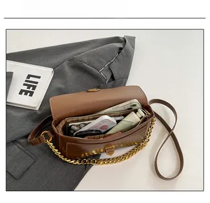 Interior view of brown stone pattern shoulder bag showing phone and cosmetics storage