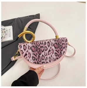 Detail of leopard print handbag with unique golden double ring handle and pink leather