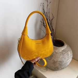 Elegant yellow velvet half-moon shoulder bag with golden chain strap and fashion text