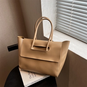 Minimalist large capacity faux leather tote bag with unique handle and flap closure