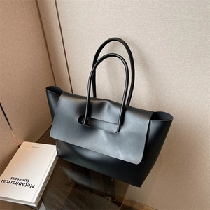 Minimalist black faux leather large tote bag shown from a 45-degree angle in high quality
