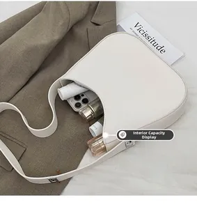 Internal view of a white crescent shoulder bag showing large capacity for essentials