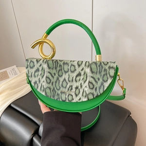 Fashionable green leopard print handbag with a unique gold spiral metal handle