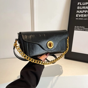 Retro black rectangular underarm bag with glossy cracked leather and gold chain strap