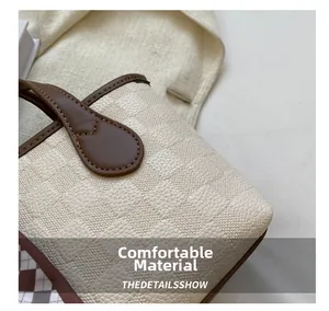 Macro detail of creamy white checkered embossed texture and brown faux leather stitching