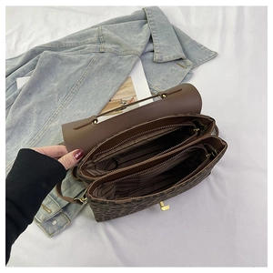 Detail of vintage leopard print handbag showing multi-layered internal compartments and zip pockets