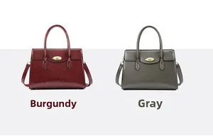 Detail view of wine red and grey leather tote bags featuring metallic twist-lock fasteners