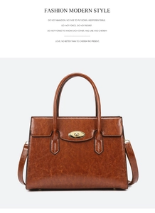 Detail view of brown vintage tote bag featuring a metallic gold twist-lock closure
