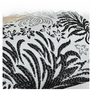 Detail of black and white floral jacquard fabric with vintage gold metal frame