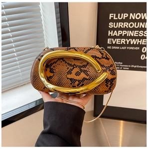 Detail of acrylic leopard print clutch with golden ring handle and chain strap
