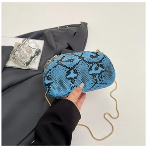 Detailed view of blue snakeskin pattern clutch bag with gold chain strap accessory